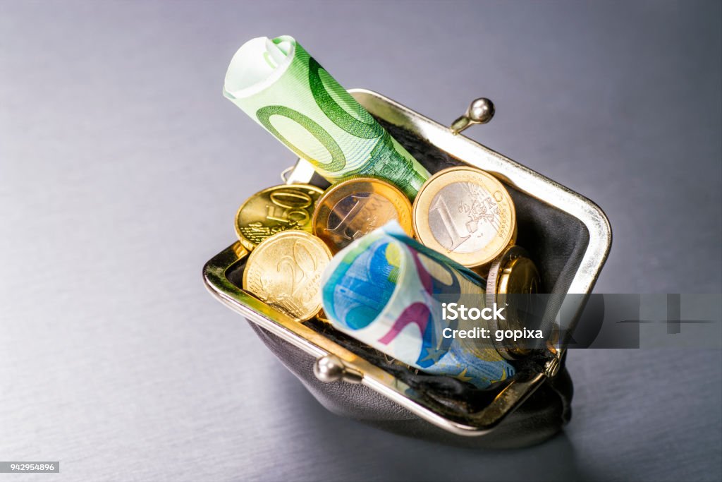 Purse with coins and bills Wallet filled with many euro coins and banknotes European Union Currency Stock Photo