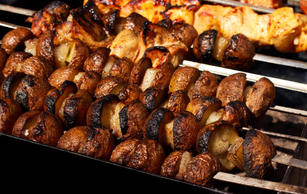 istock Pieces of potato on sticks grilling 942955766