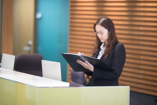 istock Young Asian receptionist working at the desk 942967086