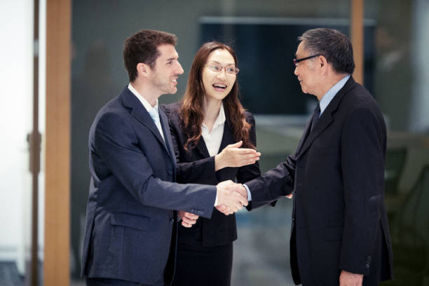 Caucasian Businessman closing a deal in Hong Kong with his Asian colleagues stock photo