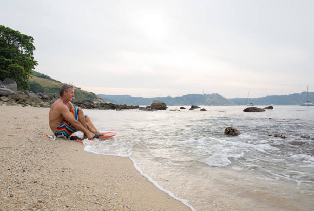 istock Man prepares to go snorkelling on beach 942974522