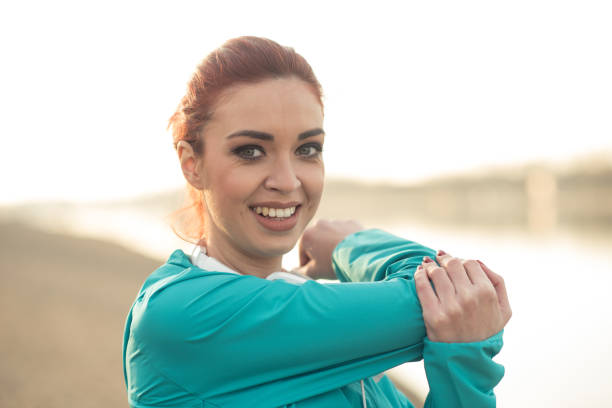 istock Fit girl stretching in the park 942974570