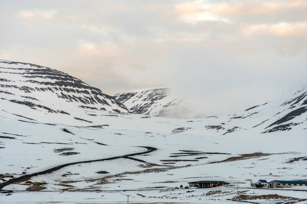 istock snow covered mountains in the clouds during sunset 942974692