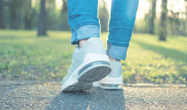 istock Walking in gray running shoes, back to camera 942975536