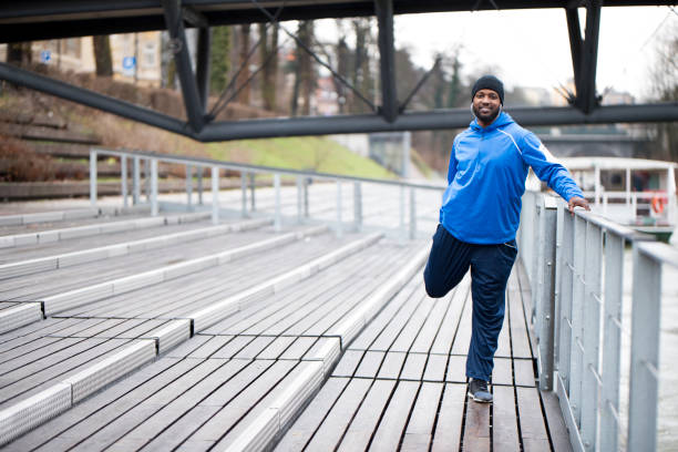 istock Young man stretching outdoors 942975852