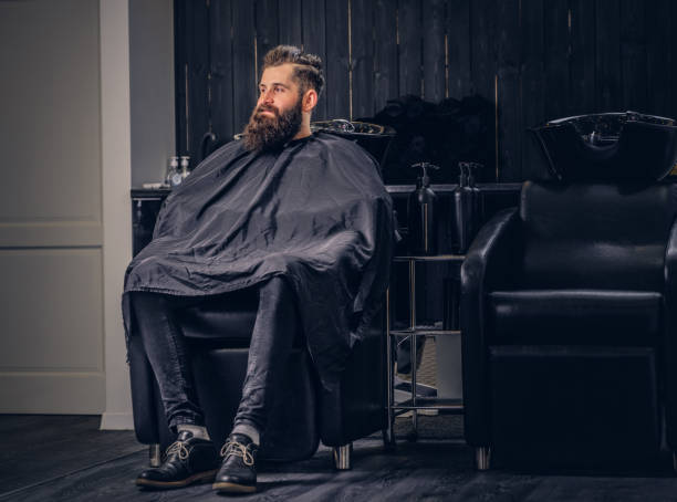istock Handsome bearded man in the barbershop. 942975890