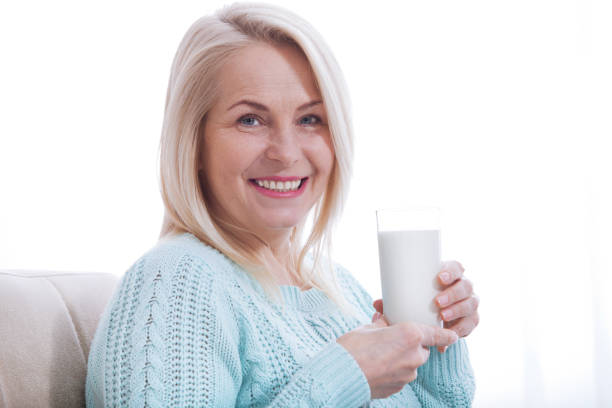 istock Happy middle aged woman drinking milk 942979376