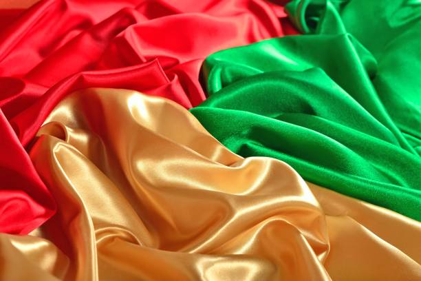 istock Natural golden, red and green satin fabric texture 942984604