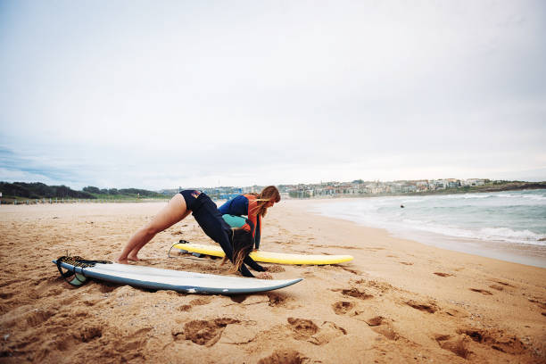 istock Women warming up for surfing 942984848