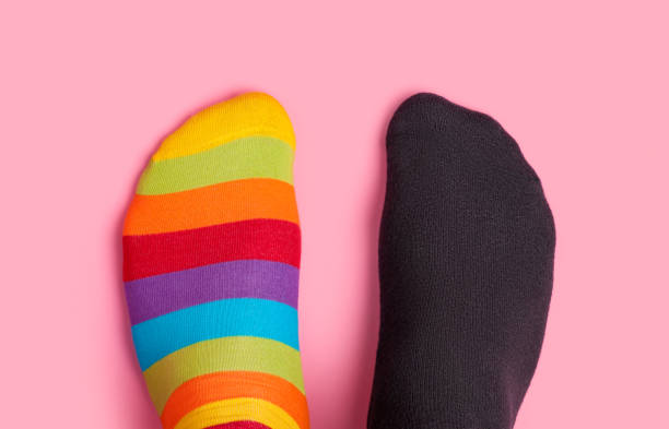 istock Foots in different colors socks on pink background 942985204