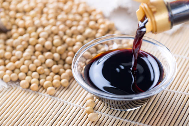 istock Pouring soy sauce into a glass bowl 942985490