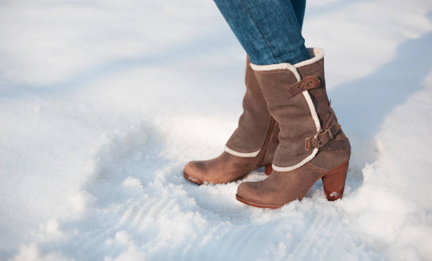 istock Gray boots with fur in the snow 942987644