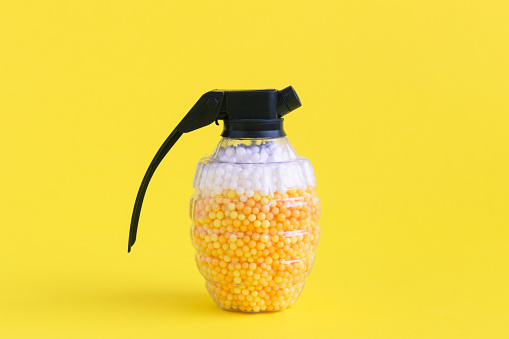 Hand grenade toy bomb full of foam balls in form of beer and foam minimal creative concept