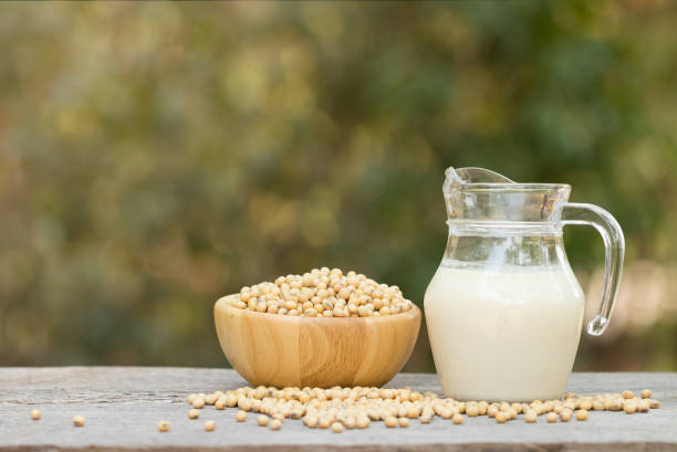 istock Soy milk and soy beans on wood background. 942992380