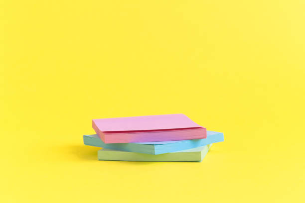 istock Pile of colorful sticky notes on pastel yellow background. 942993598