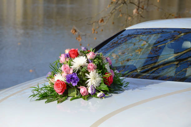 istock wedding bouquet on the modern white car closeup, spring 942996566
