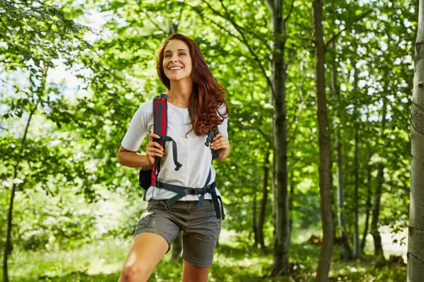 Photo of Happy woman hiking in the woods