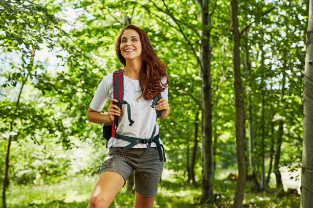 happy woman hiking in the woods - nature forest clothing smiling imagens e fotografias de stock