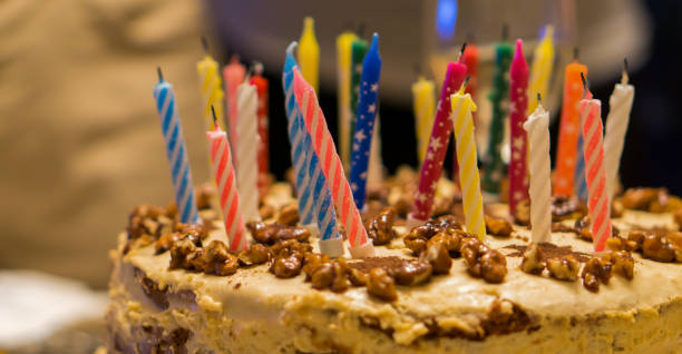 istock Birthday cake with nuts and candles background 943001430