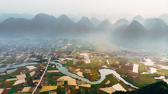 Scenic aerial view of Bac Son Valley and river at sunrise in fog, Vietnam