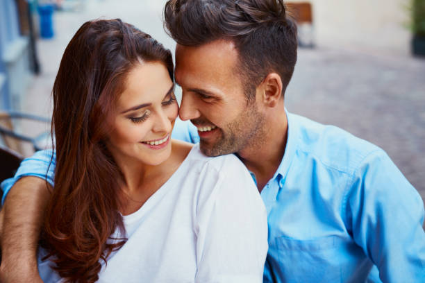istock Happy couple hugging in outdoor cafe 943005312