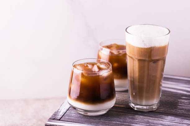 istock Iced coffee in glasses with milk. Black background 943005874