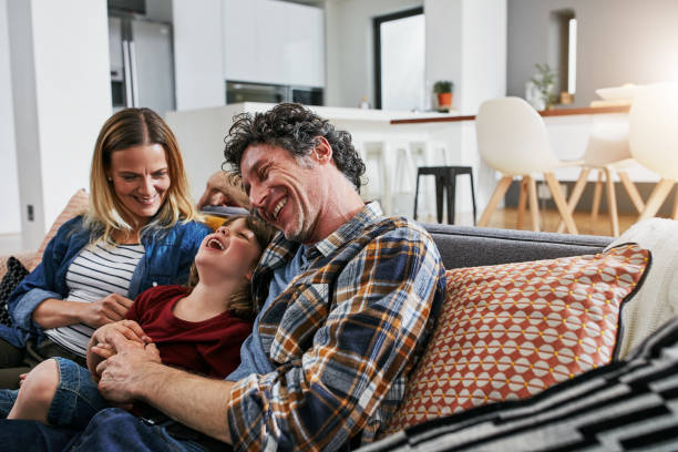 our family is all about love and laughter - comfortable relaxation sofa men imagens e fotografias de stock