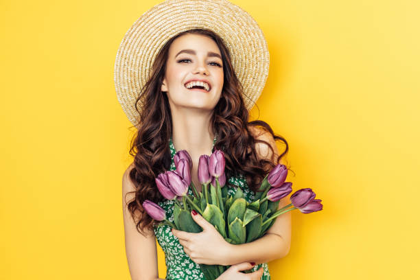istock Lovely woman with purple tulips bunch 943011996