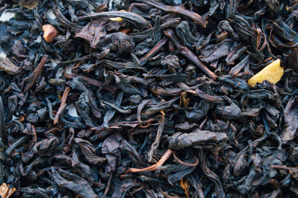 istock Dried herbal chocolate tea leaves background. View from top. Closeup shot 943012150
