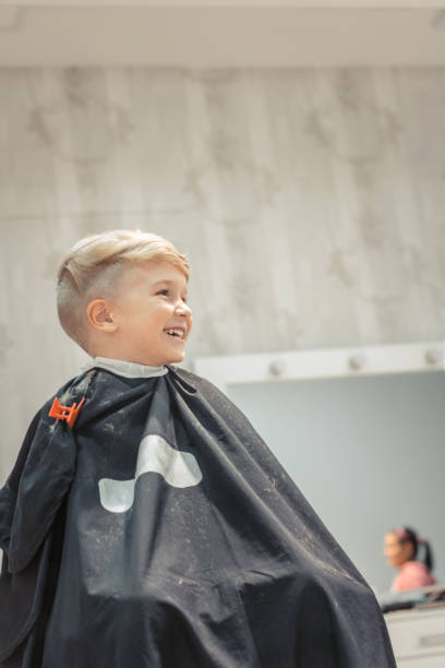 istock Happy kid at barber shop. 943012356