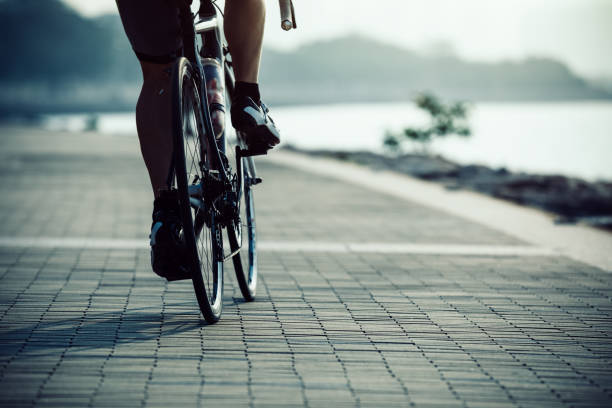 istock cyclist riding bike on seaside 943012412