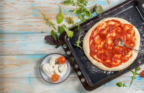 istock Top view cooking pizza on wooden table. 943015006