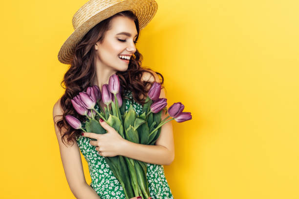 istock Lovely woman with purple tulips bunch 943015672