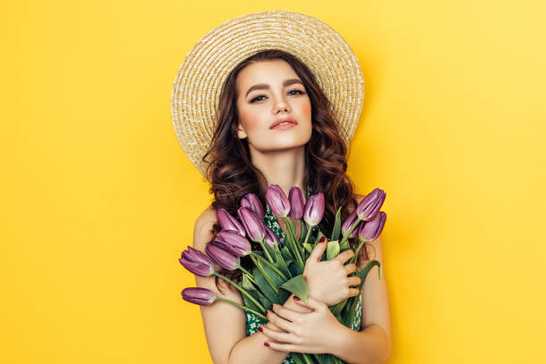 istock Lovely woman with purple tulips bunch 943018134