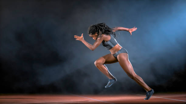 Female sprinter running Female sprinter running from starting line on track. woman sprint stock pictures, royalty-free photos & images