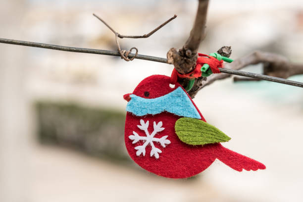 Small red handicraft bird made of felt hanging on a wire in Valun, Cres Croatia