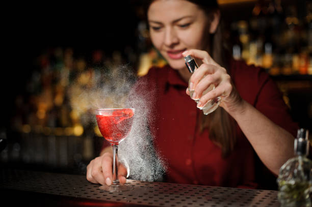 istock bartender girl adds peat whiskey to alcoholic cocktail 943031206