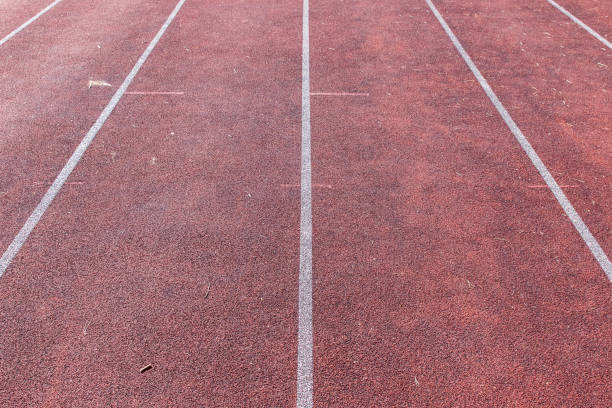 istock White lines and texture of running racetrack 943031554