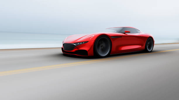 istock red car driving on a road by sea 943034566