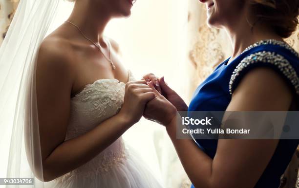 Bride On Wedding Day Holding Her Mothers Hands Concept Of Relationship Between Moms And Daughters Stock Photo - Download Image Now