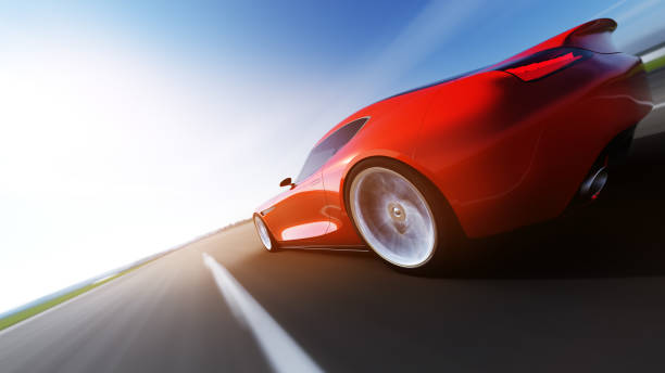 istock red car driving on a road 943037696