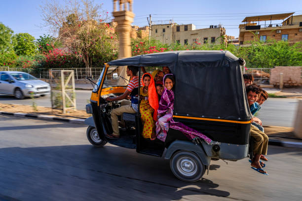 group of happy gypsy indian children riding tuk-tuk, india - jinrikisha imagens e fotografias de stock