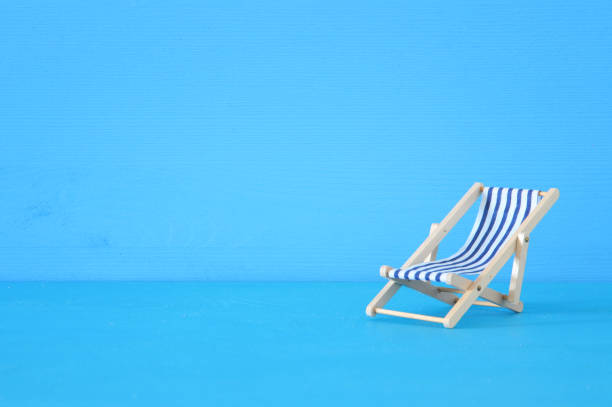 istock image of beach chair over blue background. 943041518