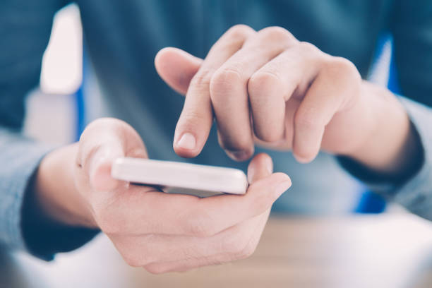 istock Close-up of male hands touching smartphone screen 943044872