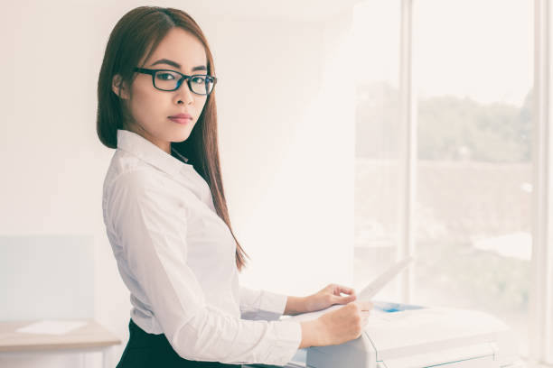 istock Confident Asian Woman Using Photocopier in Office 943045228
