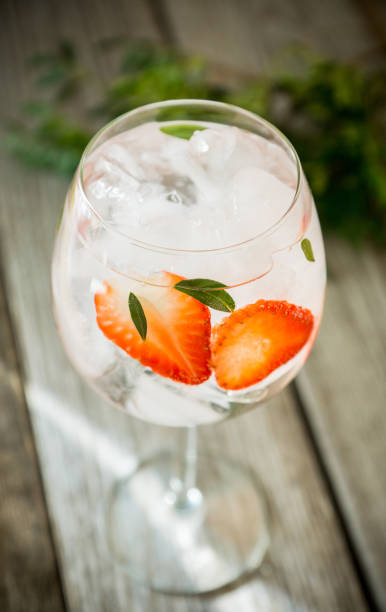 istock Gin with strawberry and ice in wine glass 943055222