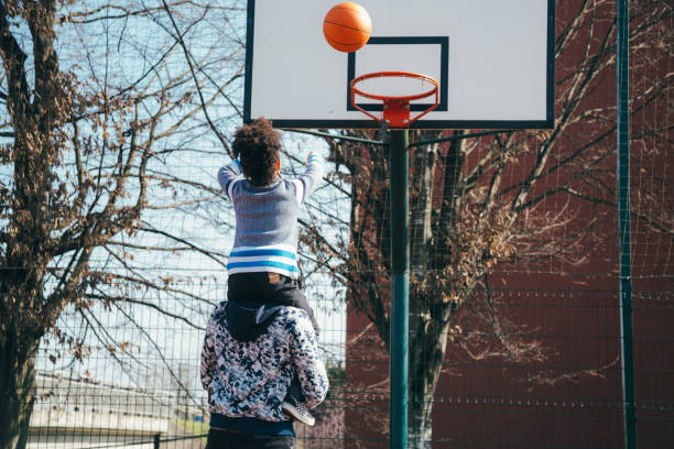 istock Father and son playing basketball 943058596