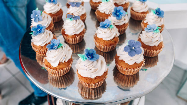 istock Cupcakes with whipped cream and frosting on a silver table in stainless steel 943058764