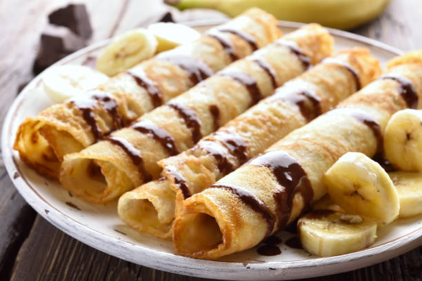istock Crepes roll with banana slices 943058942