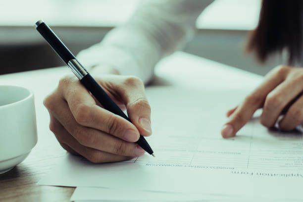 istock Closeup of Woman Completing Application Form 943069786